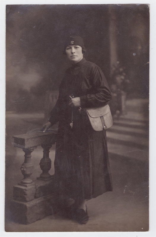 Femme portant une sacoche et tenant un sifflet (employée du tramway, du chemin de fer ?)