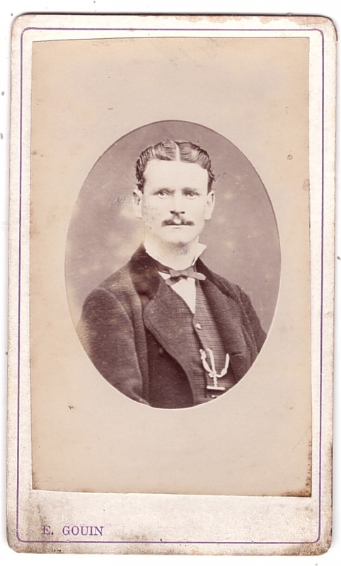 Homme avec sa chaîne de montre accrochée à son gilet